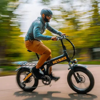 Man riding an Urban Electrica e-bike in park, showcasing affordable electric biking under $1500 for urban commuting.