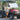 TrailMaster Taurus 50EV 4-seat electric golf cart with aluminum wheels, off-road tires, LED lights, and turn signals parked outdoors.