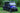TrailMaster Taurus 80ED-GV electric golf cart with extended roof and 6 seats, shown in blue on grassy terrain, ideal for beach outings.