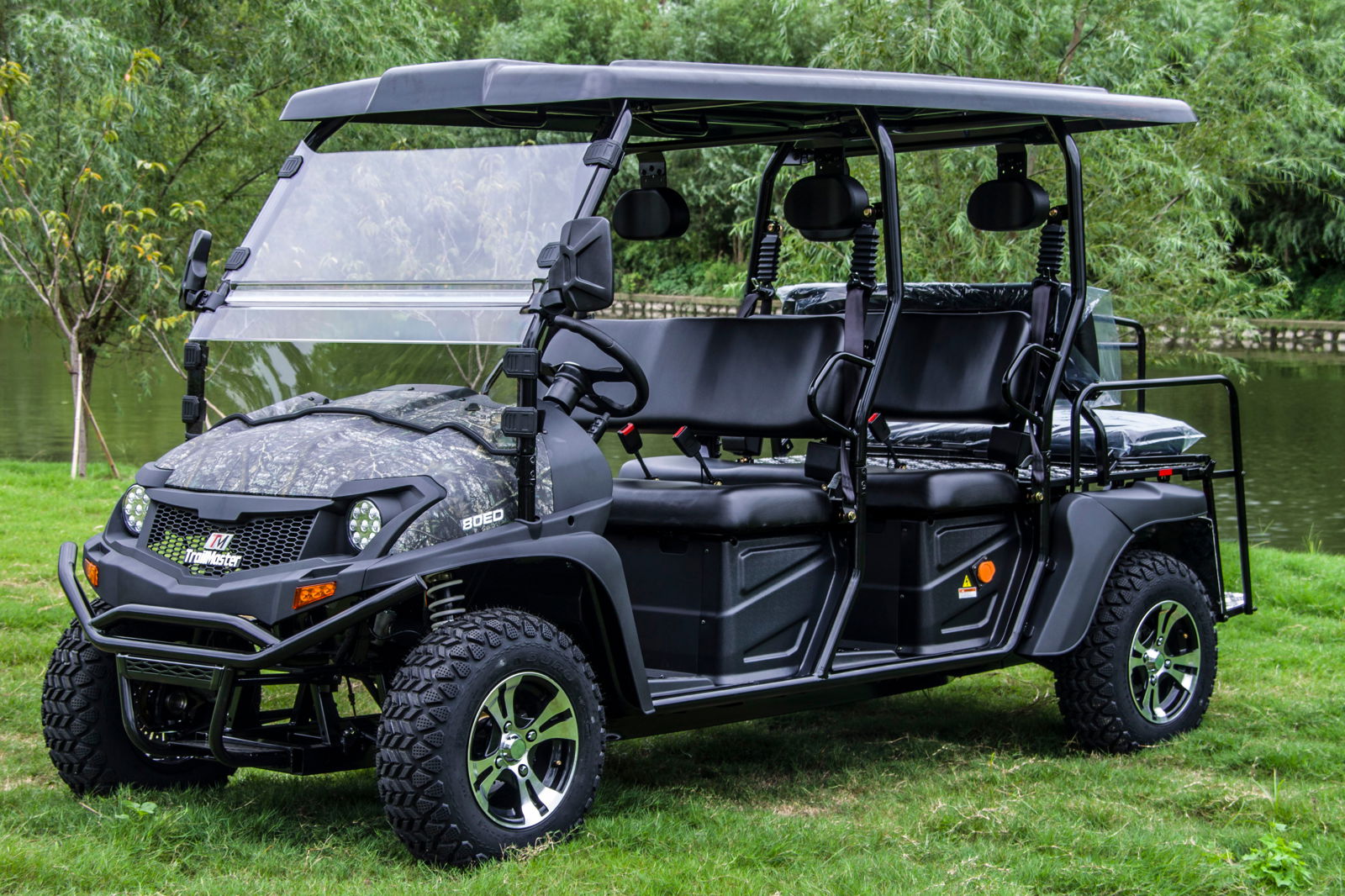 TrailMaster Taurus 80ED-GV 6-seat electric golf cart with extended roof, featuring two front-facing rows and convertible cargo area.
