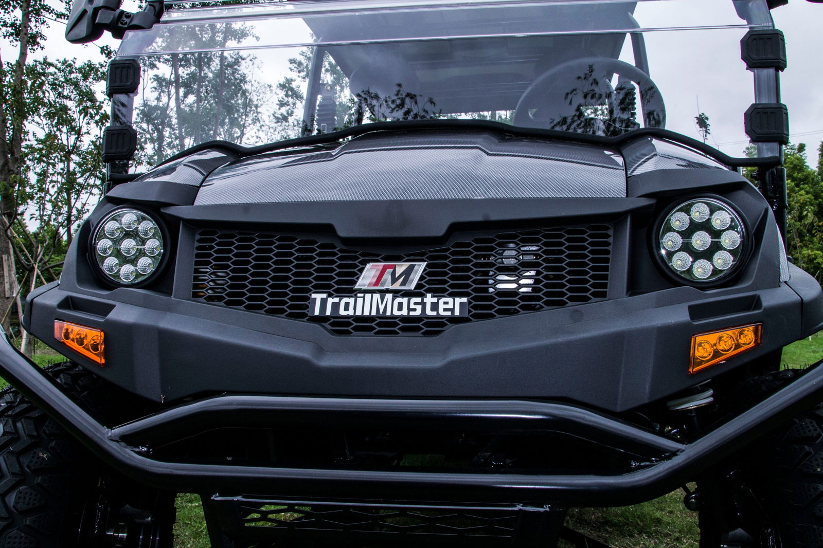 Front view of TrailMaster Taurus 80ED-U electric golf cart with LED headlights and TM logo.