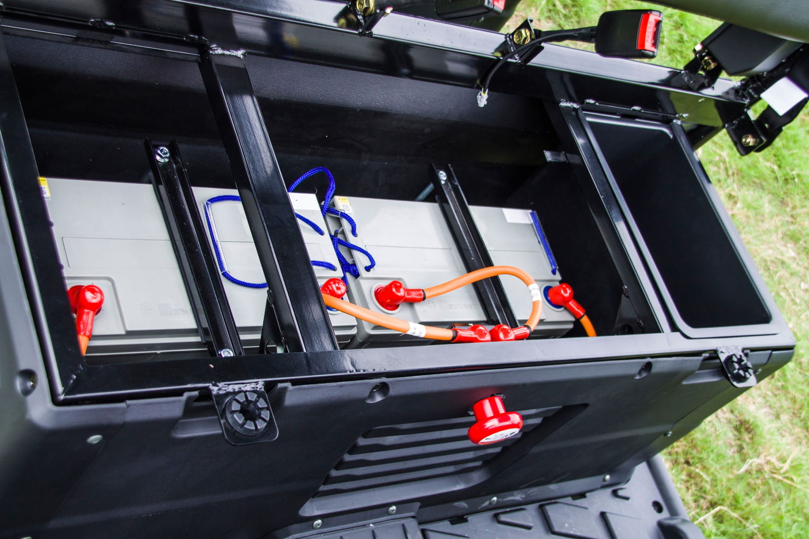 Close-up view of battery compartment in TrailMaster Taurus 80ED-U 4-seat electric golf cart with 72V power system and components.