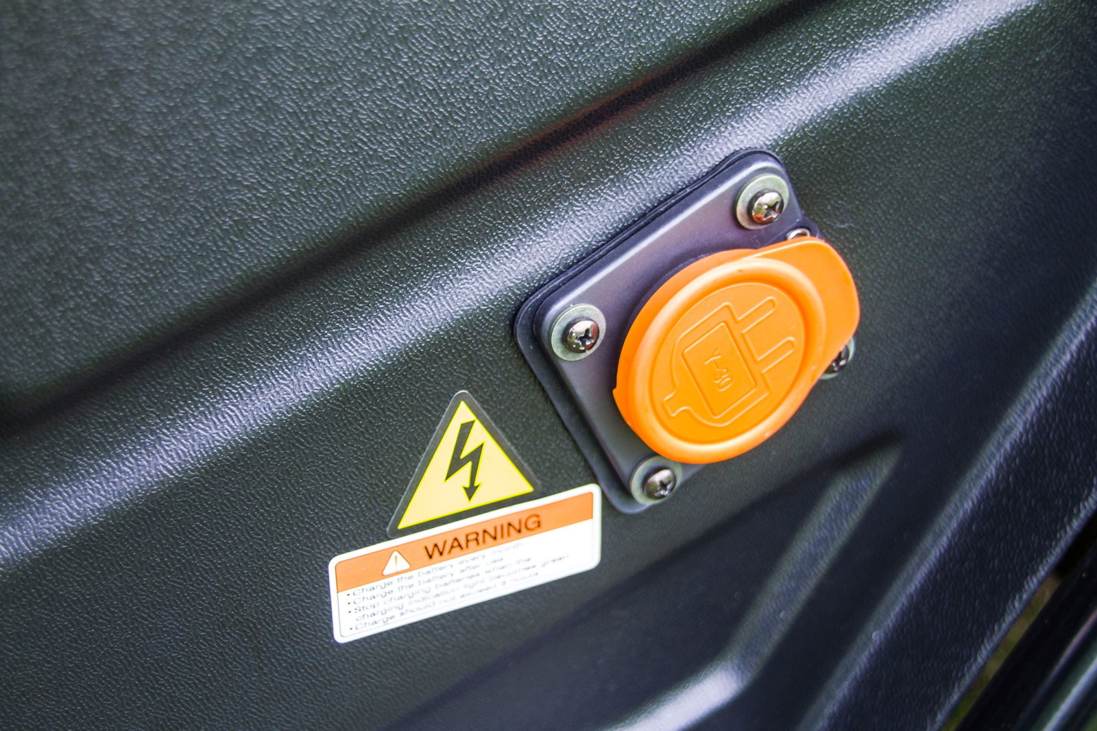 Close-up of TrailMaster Taurus 80ED-U electric golf cart charging port with warning label