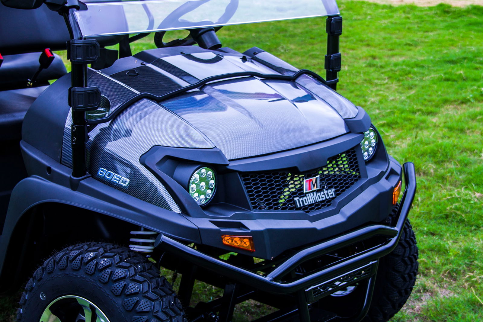 Front view of TrailMaster Taurus 80ED-U electric golf cart with aluminum alloy wheels and LED headlights.